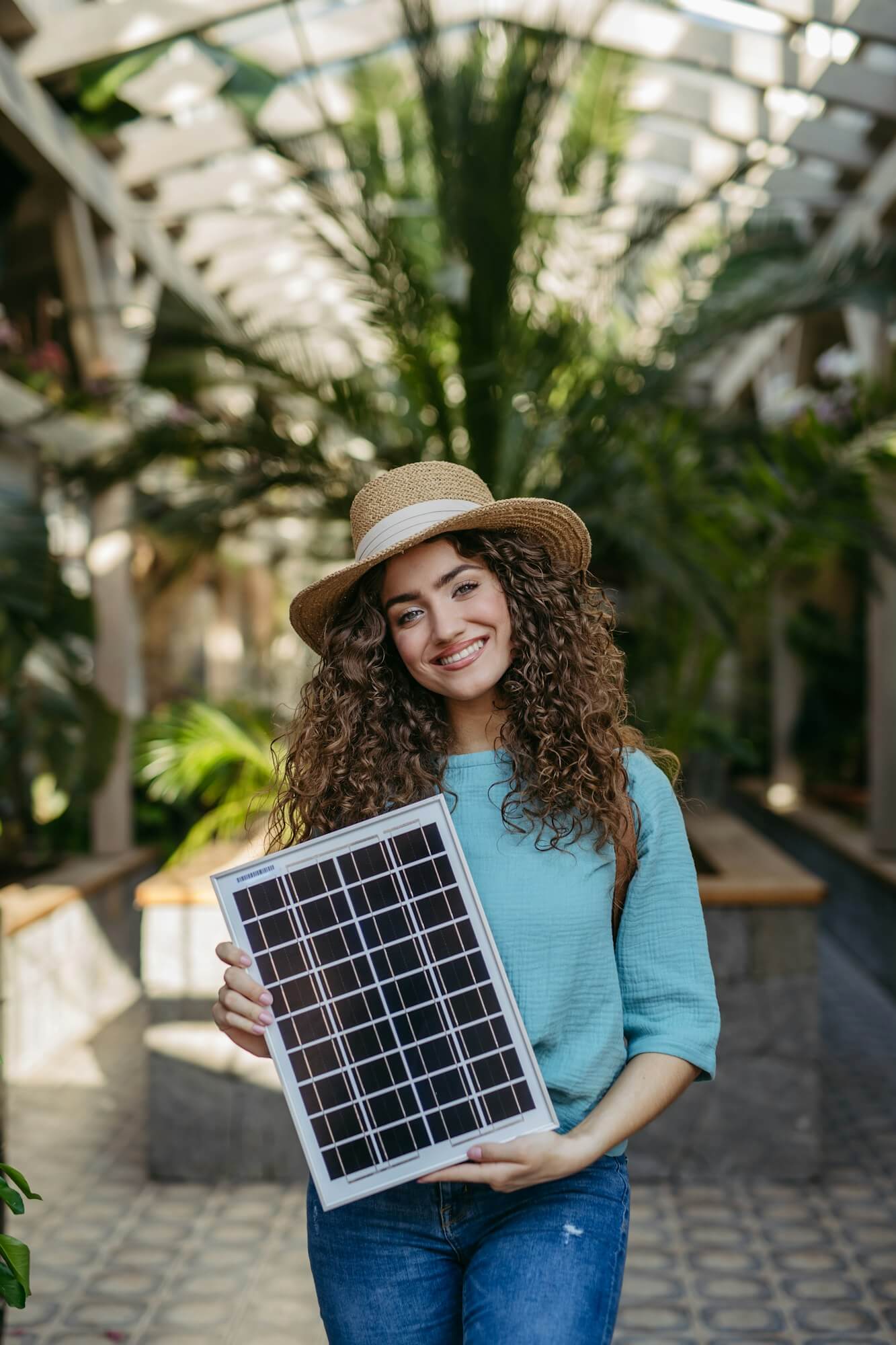 young-woman-in-botanical-garden-holding-solar-panel-concept-of-green-energy-.jpg